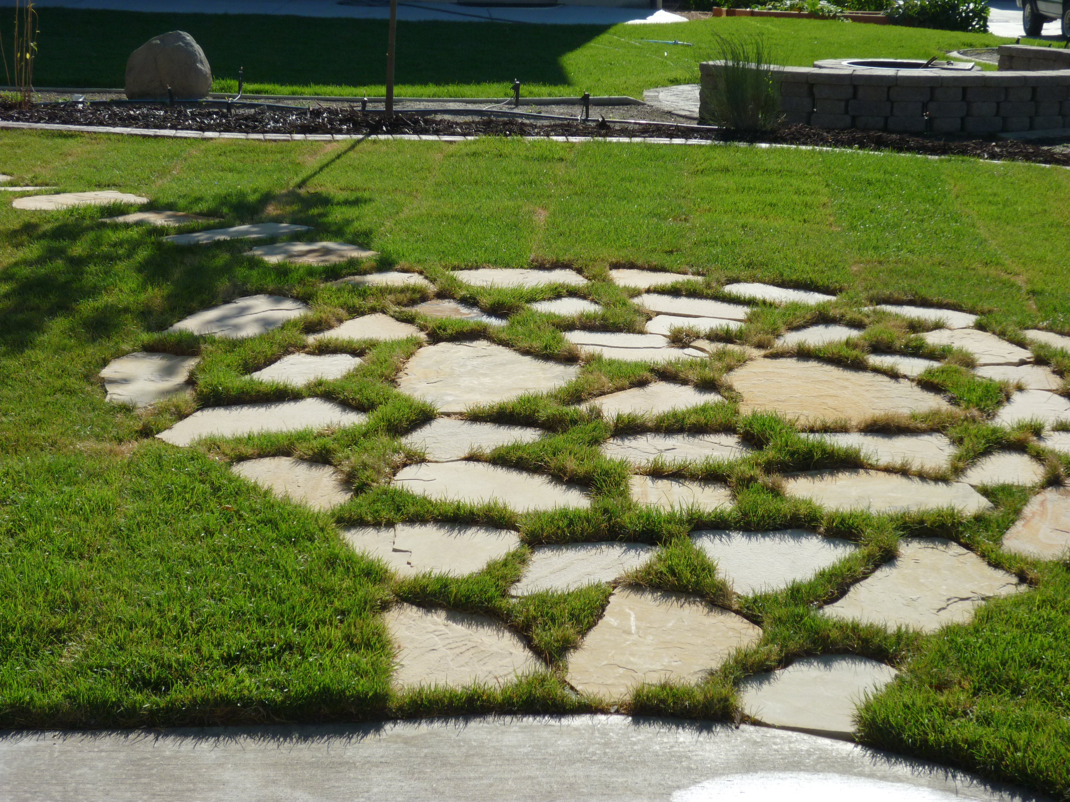 Flagstone patio in grass | Chris Jensen Landscaping in ...
